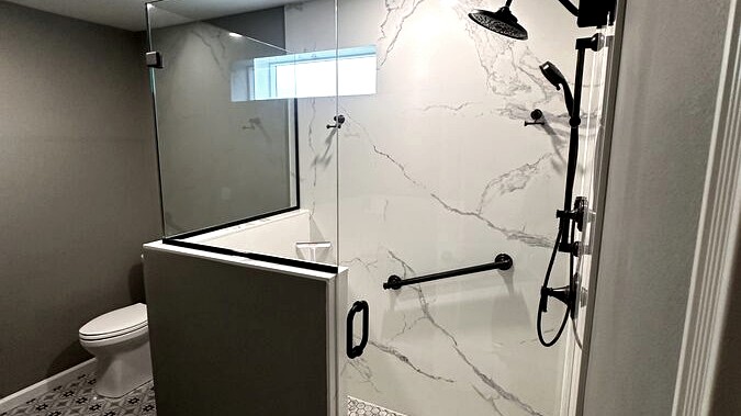 Full bathroom renovation with walk-in shower and patterned tile floor