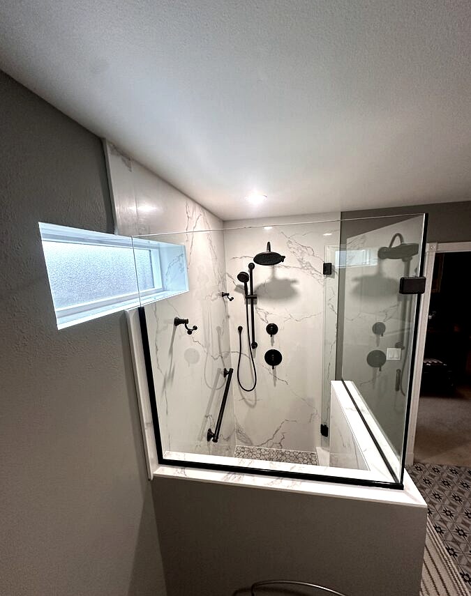 Walk-in shower with frameless glass and hex tile floor