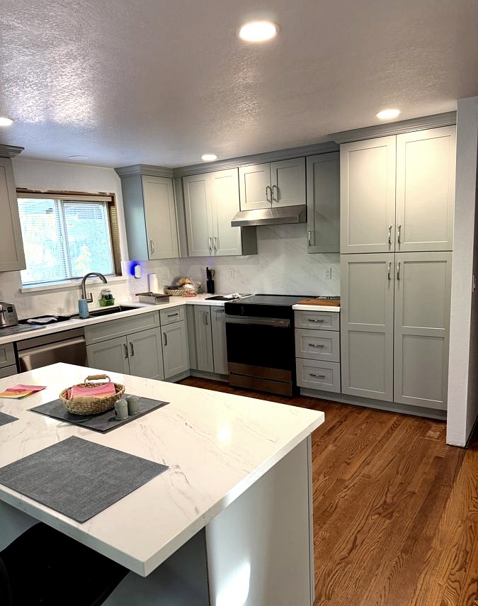 Custom kitchen with grey shaker cabinets and quartz island